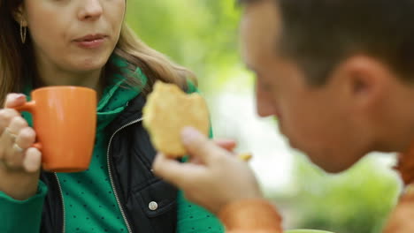 happy couple drinking tea. young couple enjoying time in nature and drinking tea
