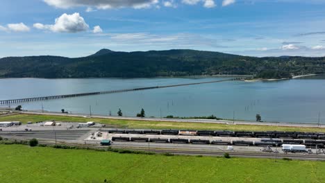 Aerial-view-of-a-train-depot-overlooking-Fidalgo-Bay-in-Anacortes,-WA