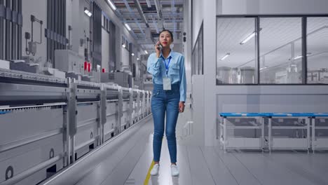 full body of asian female at pharmaceutical factory, vaccine production facility, she is speaking with someone in the phone