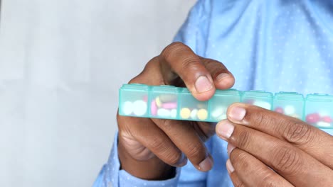 person using a daily pill organizer