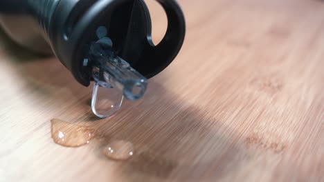 metal water bottle rotating on a wooden surface with water droplets