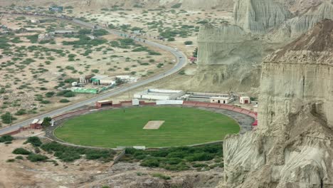 cricket oval with lush green grass in rural pakistan landscape