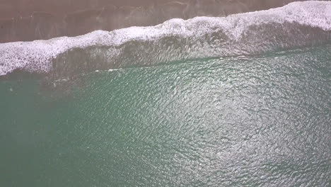 drone shot flying over the beach in the town of playas general villamil, ecuador-1