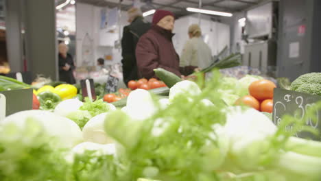 blurry old woman shopping vegetables in a local market montpellier france