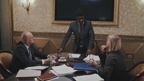 african american lawyer holding business meeting with colleagues