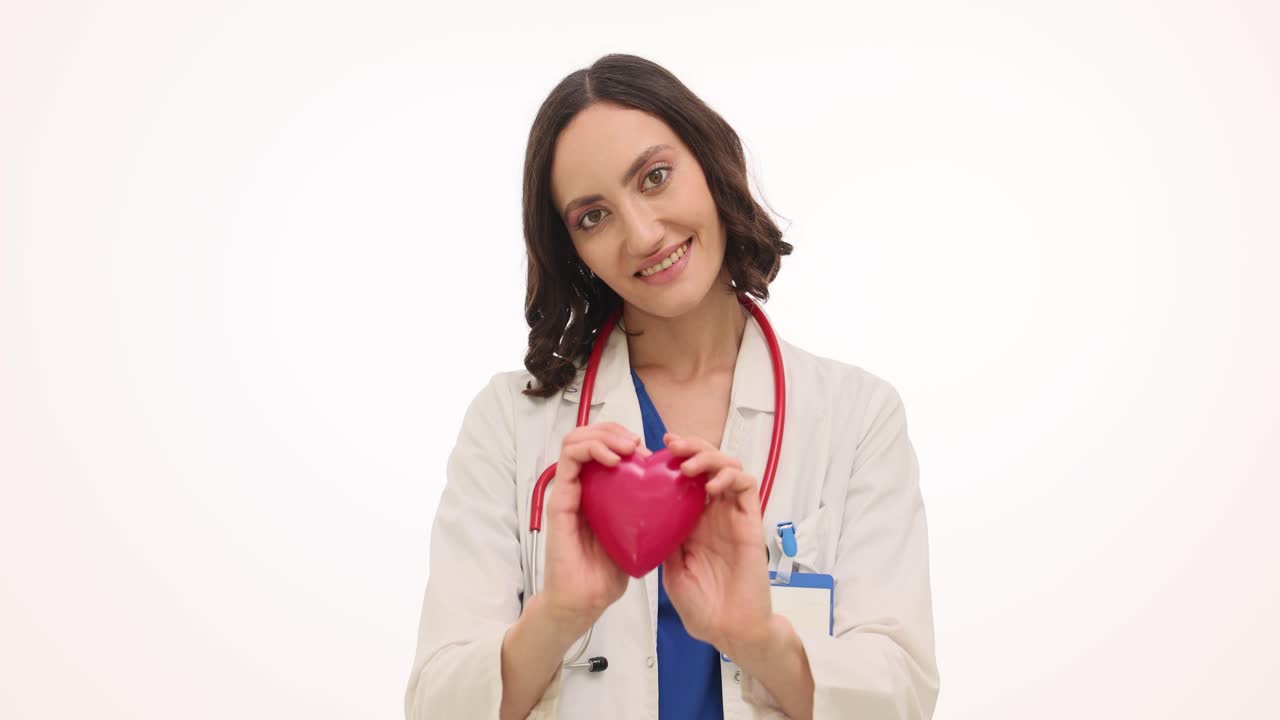 Female Doctor Holding a Red Heart Symbolizing Health and Care