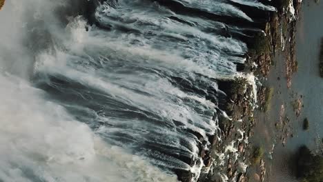 vertical aerial view victoria falls, shungu namutitima at the border of zimbabwe and zambia in africa