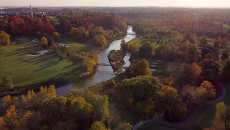 reveal aerial view at park with a river in the middle of it