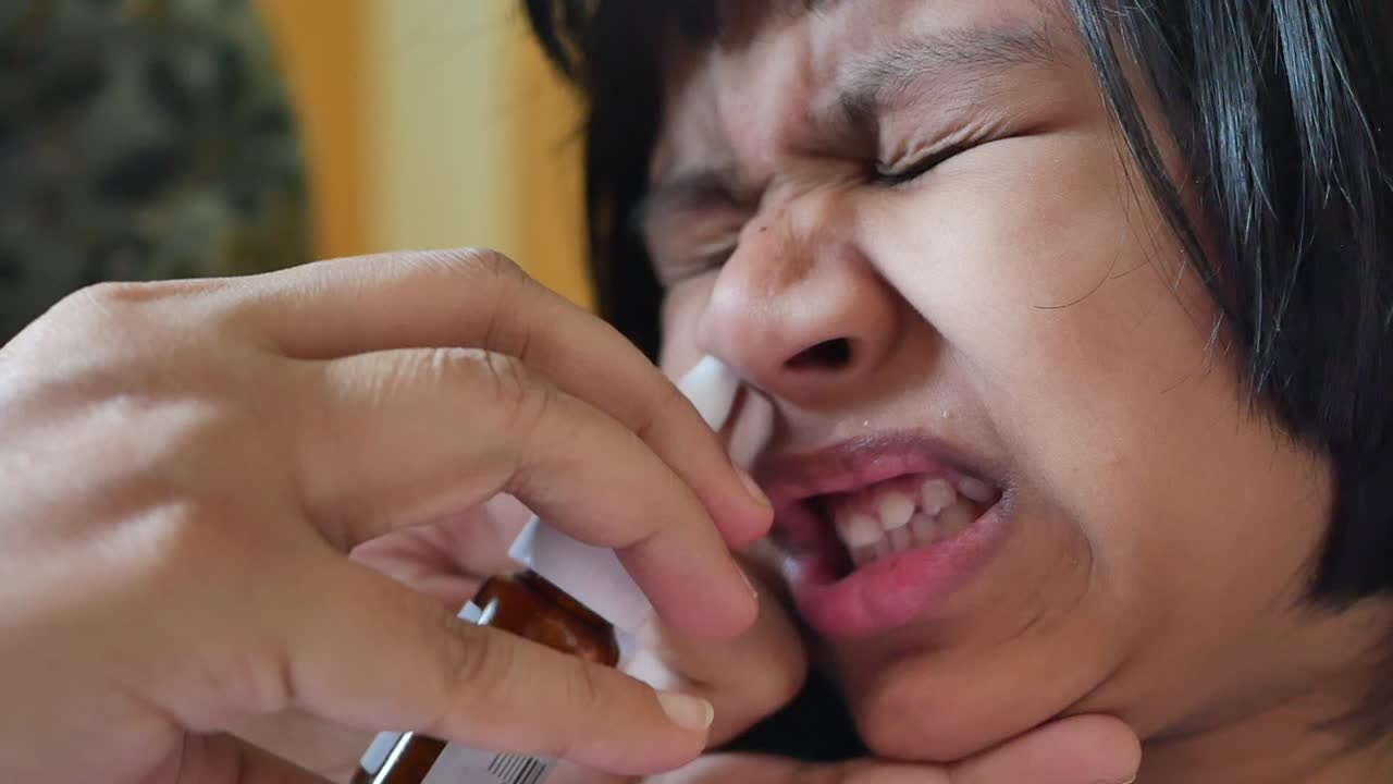 Child receiving nasal spray