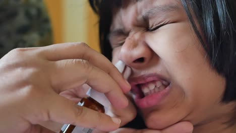 child receiving nasal spray