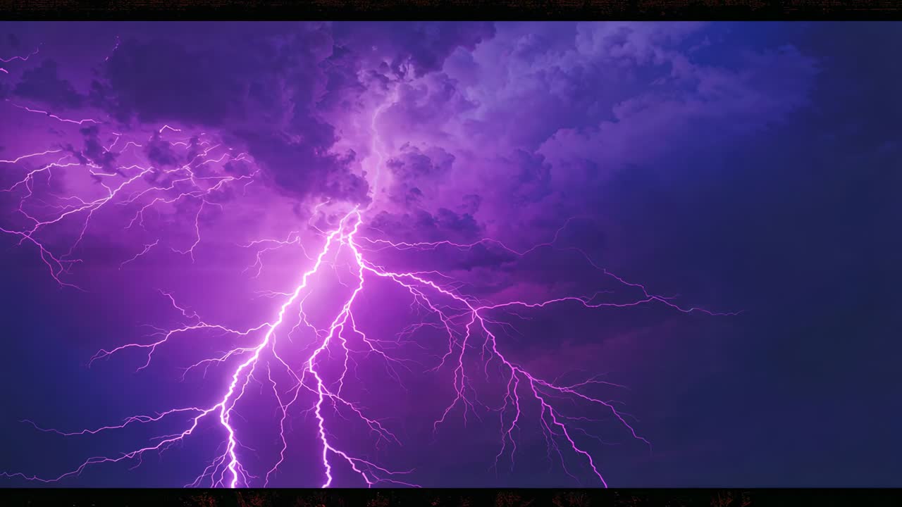 Flashing purple lightning cluster arcing from charged storm cloud over rural treeline lighting sky