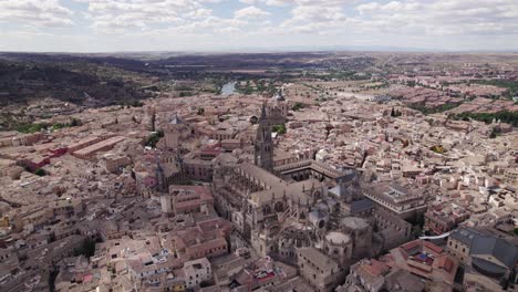 Historical-Spanish-town-of-Toledo,-aerial-circling-around-Toledo-Cathedral