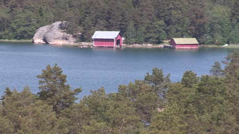 lake in finland with hut and coniferous forest