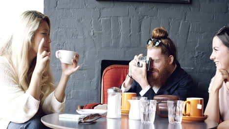 photographer taking photograph with retro vintage camera