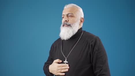 el anciano cristiano cuelga el collar de la cruz alrededor de su cuello y respeta y cree en jesucristo.