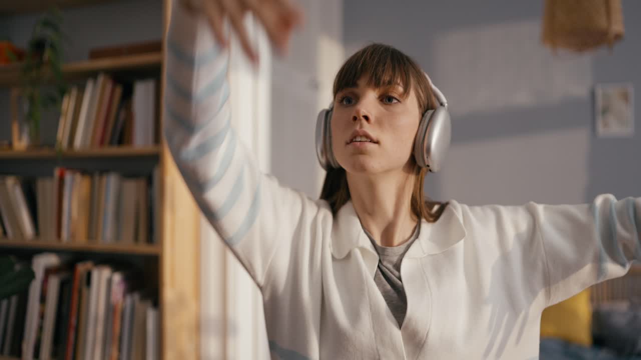 A woman is listening to music in a room