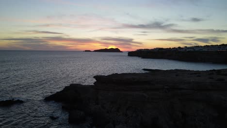 aerial shot of an incredible sunset in the background on the island of ibiza