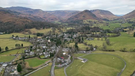 cinematic cumbrian aerial village landscape, aerial view of grassmere, village, town in the english lake district, uk