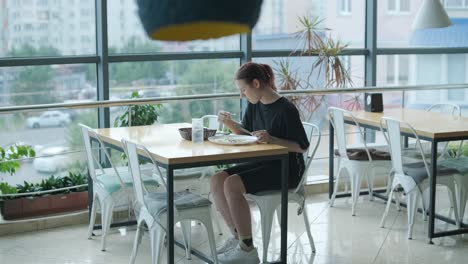 girl eating salad in cafe