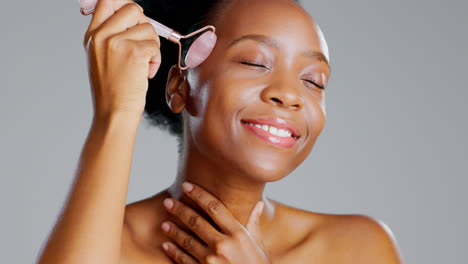rose quartz, black woman and face roller massage