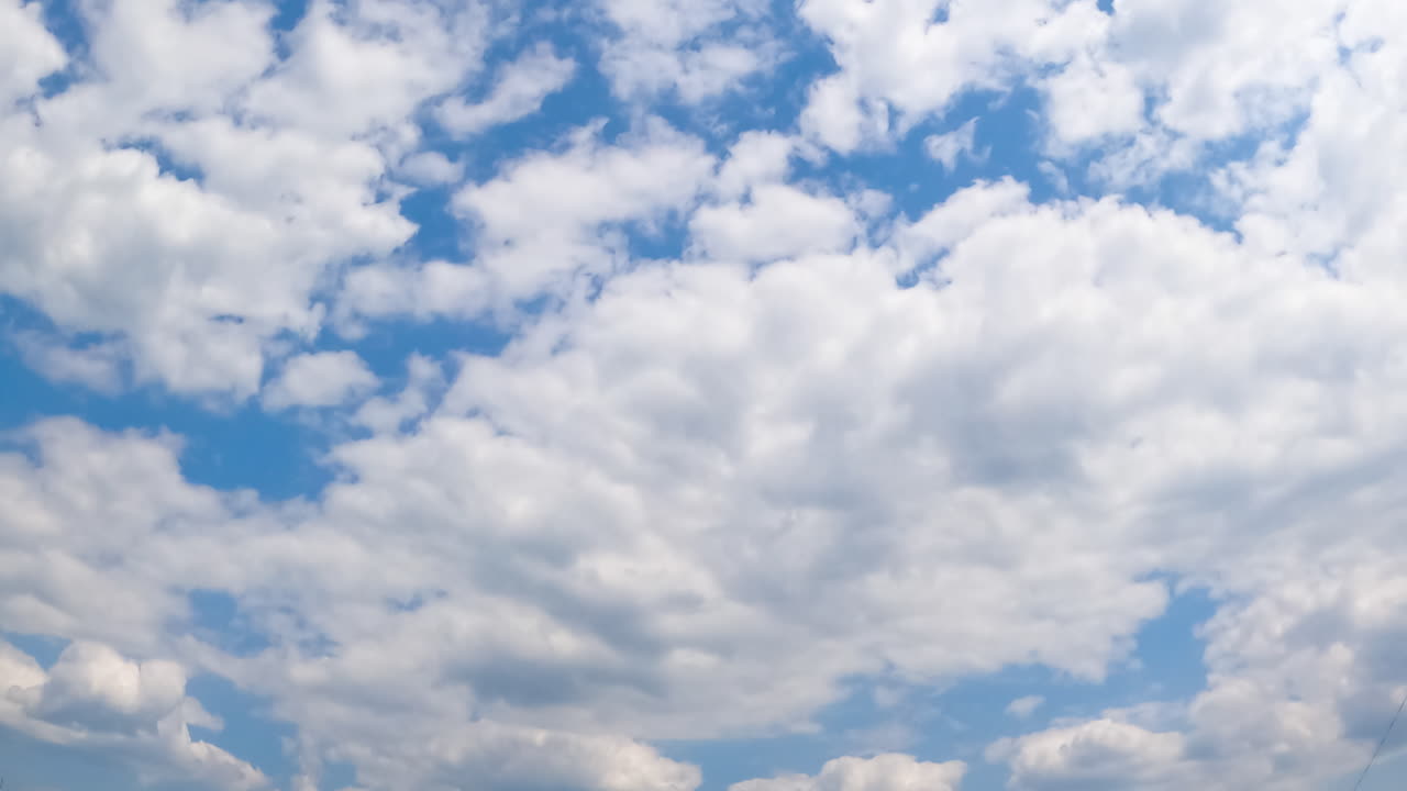 White cloudscape transformation in the atmosphere. Big and small cotton clouds moving from low angle view. Timelapse.