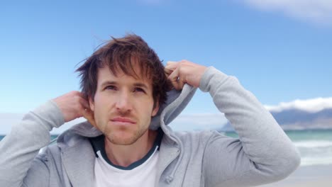 man wearing hoodie at beach