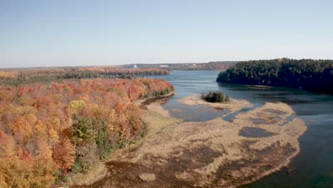 au sable river in michigan during fall colors with drone video moving low and forward