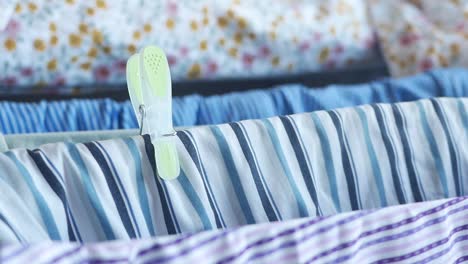 close-up of clothes hanging on a clothesline with pegs