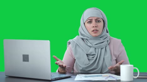 angry muslim businesswoman talking to camera green screen