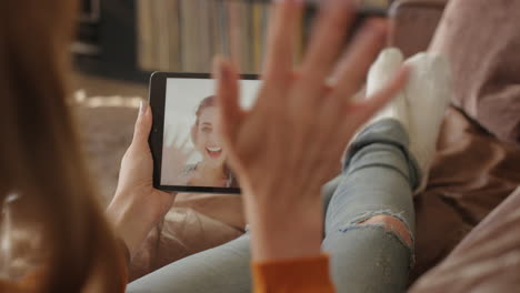 woman using digital tablet holding greeting waving