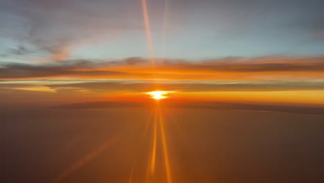 incredible sunset over the mediterranean sea from a jet cockpit flying westbound naer valencia’s coast, spain