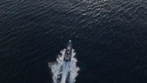 Aerial-tracking-shot-of-luxury-fast-speedboat-on-blue-ocean-in-Greece-during-summer