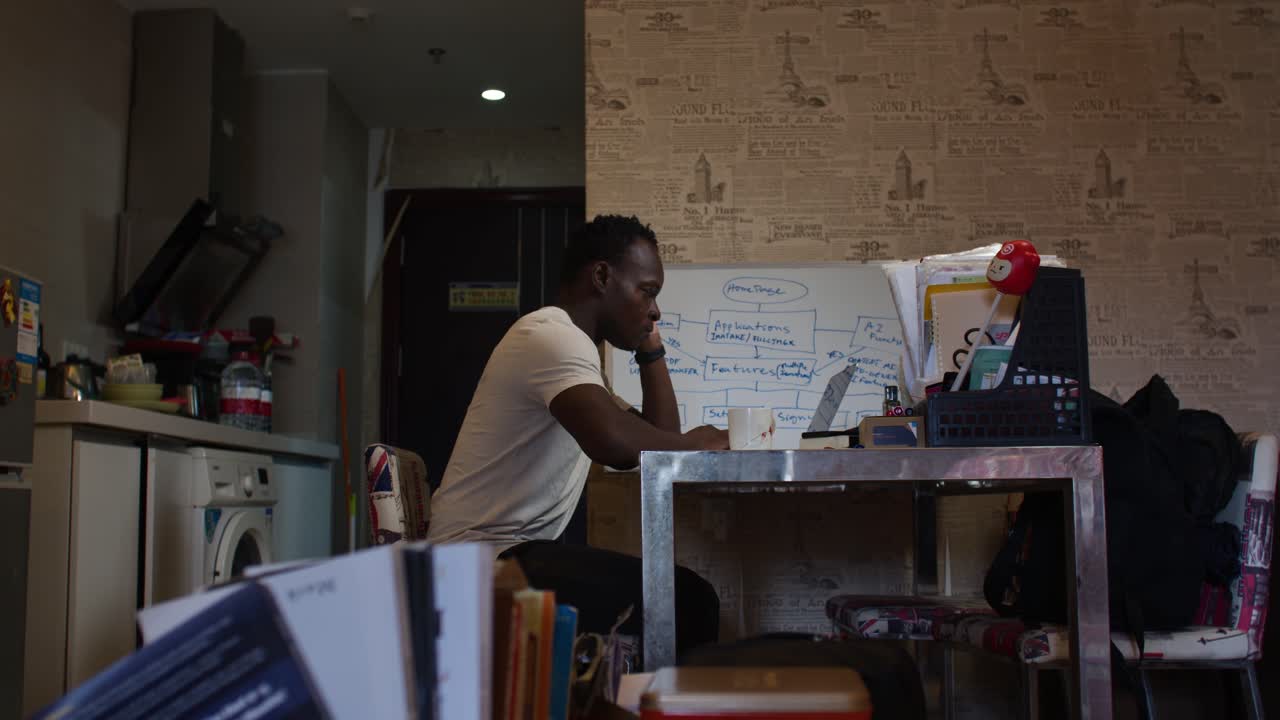 Person preparing drink in home office, casual workspace setting