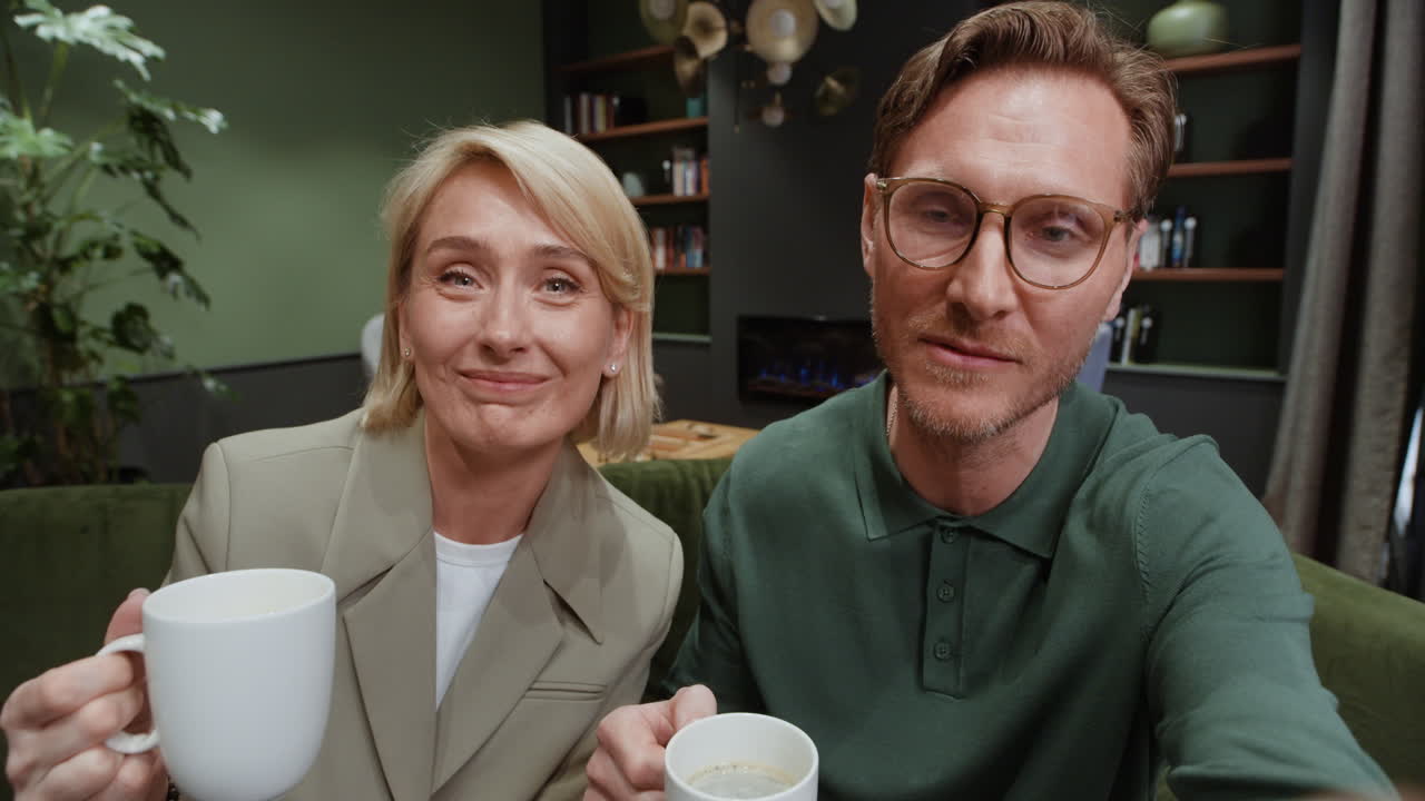 Couple Enjoying Coffee and Conversation in a Cozy Cafe