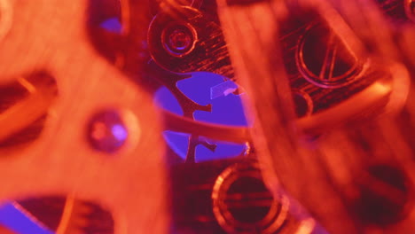 Macro-Shot-Of-Vintage-Clock-Mechanism-In-Red-Light