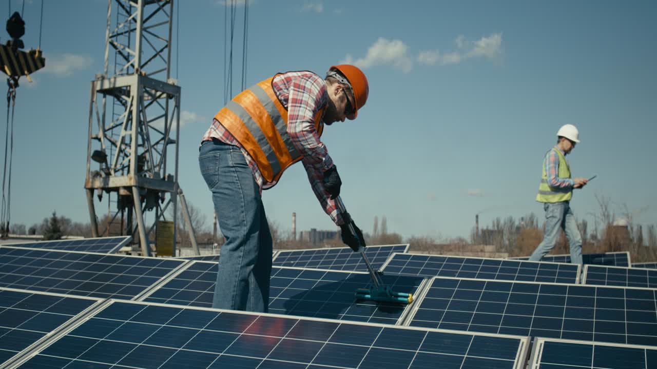 Solar Panel Cleaning by Maintenance Worker