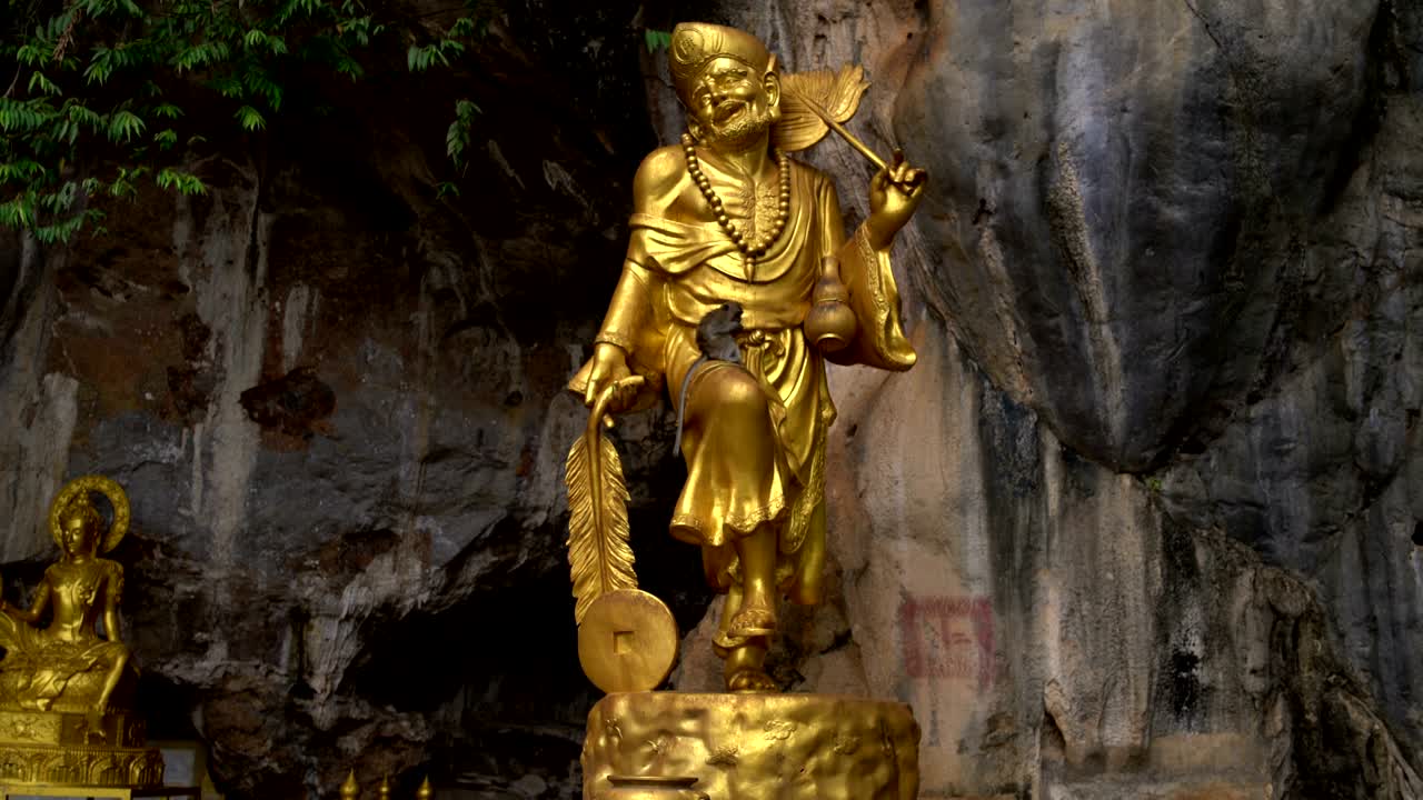 On the golden statue of the deity sits a monkey