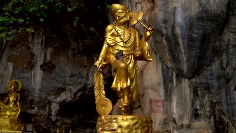 on the golden statue of the deity sits a monkey