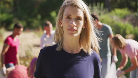 Caucasian-woman-smiling-and-looking-at-camera-during-river-clean-up-day