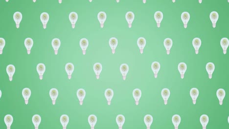 Animation-of-multiple-falling-light-bulbs-with-trees-inside-on-green-background