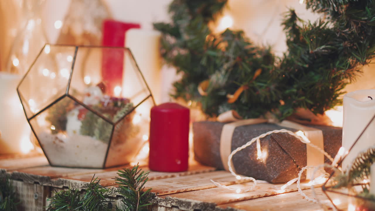 close up shot of the men's hands, who holds beautifully packaged boxes with gifts, the person will put them under the tree and give it to friends or family during the celebration of the new year