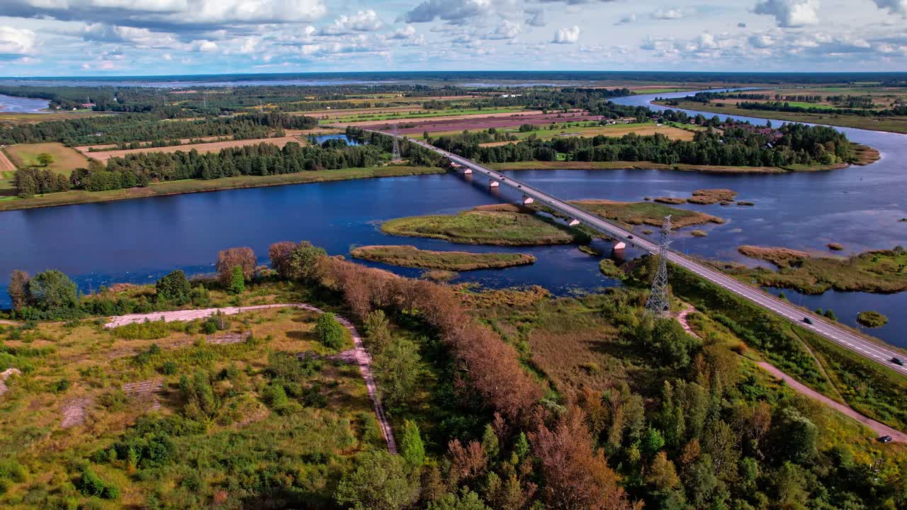 Scenic aerial view of a bridge crossing a river in Latvia's countryside