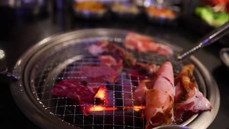 beef and bacon grilling on a barbecue