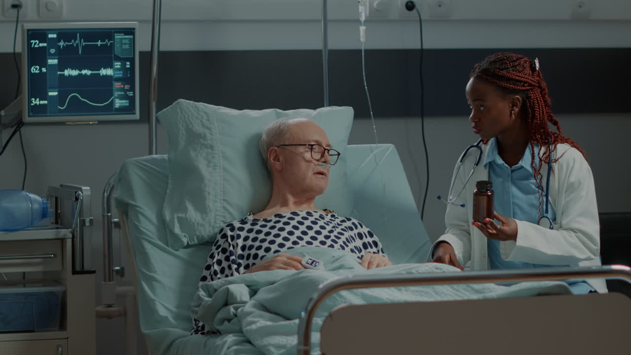 African american surgeon showing bottle of pills to patient
