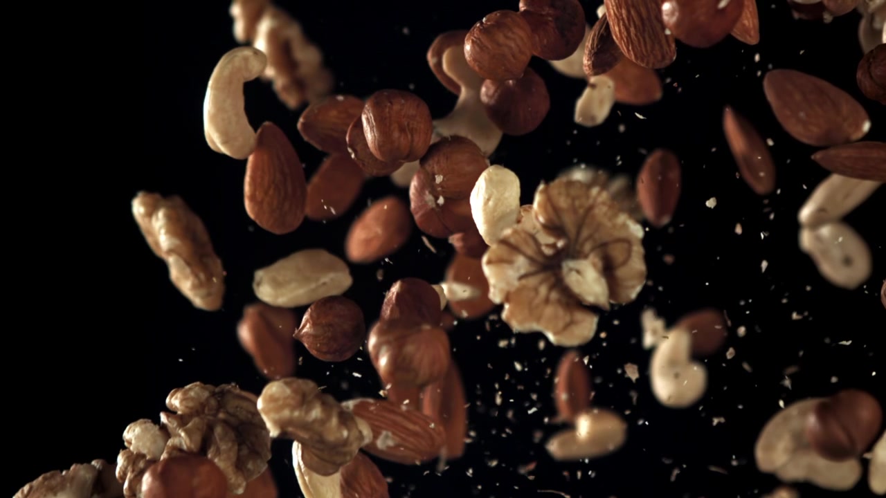 Mixed Nuts Falling and Flying in Slow Motion on Black Background