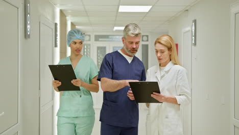 medical professionals discussing in hospital corridor