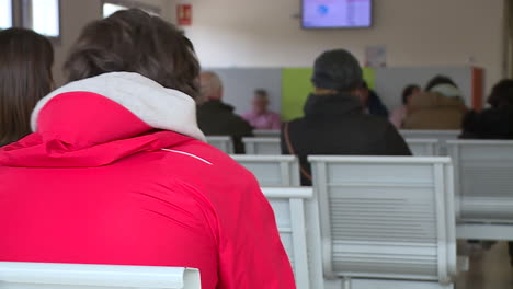 people waiting in a hospital or clinic waiting room