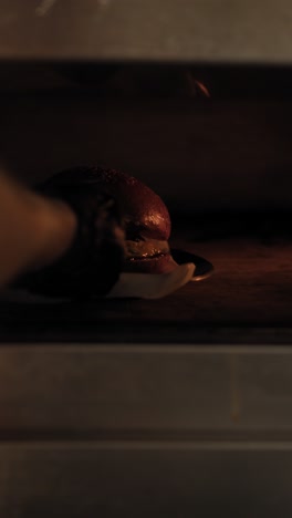 chef putting the gourmet burger inside the oven