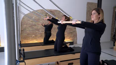 women exercising on reformer during pilates workout