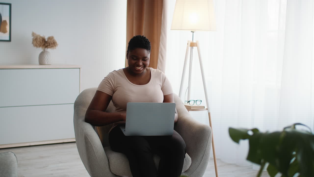 Woman Working on Laptop at Home